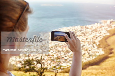 Young woman on mountain, photographing view, Lions Head Mountain, Western Cape, Cape Town, South Africa, Africa