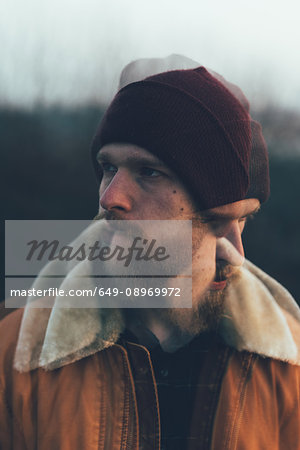 Double exposure portrait of bearded young male hipster