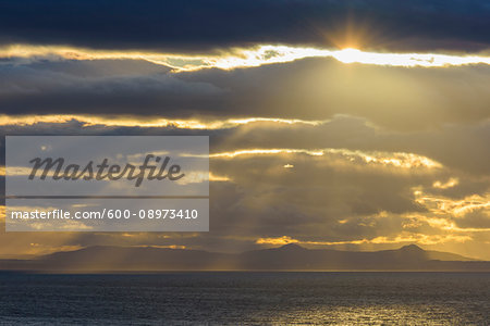 Firth of Forth with clouds and sunbeams at sunset at North Berwick in Scotland, United Kingdom