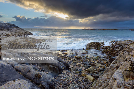 Surf along the Scottish coast at sunrise in spring at Mallaig in Scotland, United Kingdom