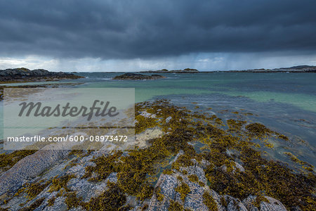 Scottish coast in spring with rain clouds over the ocean at Mallaig in Scotland, United Kingdom