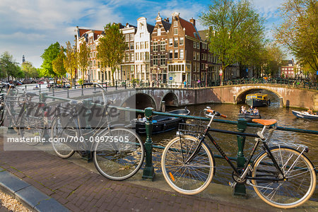 Bicycles parked along a bridge crossing the Leidsegracht Canal in the city center of Amsterdam, Holland