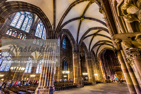 Tourists touring the interior of the Strasbourg Cathedral (Cathedral Notre Dame of Strasbourg) in Strasbourg, France