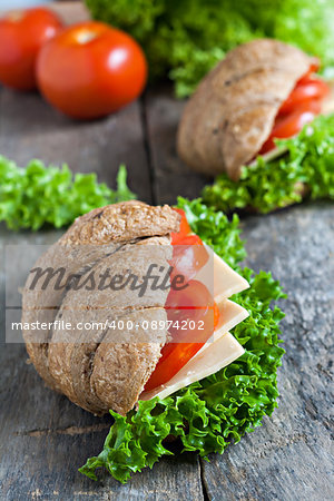 grain vegetarian croissant sandwich on a wooden background old.