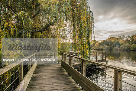 Wood footbridge on the Erdre river in autumn (Nantes, Loire Atlantique)