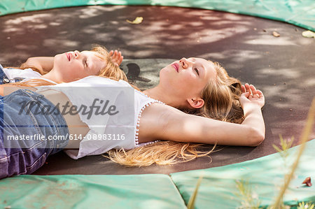 Girls lying down on trampoline
