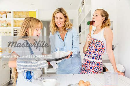 Mother and daughters baking in kitchen