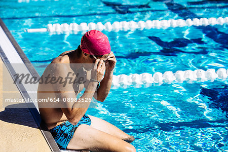 Swimmer sitting at end of pool