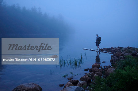 Male hiker by misty river, Acadia, Maine, USA