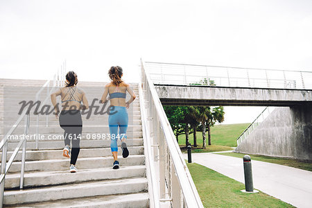 Two you women exercising outdoors, running up steps, rear view, steps, South Point Park, Miami Beach, Florida, USA