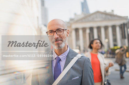Portrait confident businessman on urban city street, London, UK