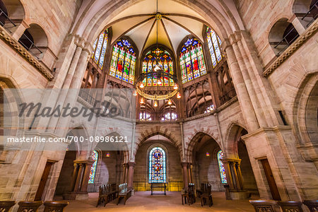 Interior of the Basel Cathedral (Basel Minster) of an archway surrounded by stained glass window with a vaulted ceiling in Basel, Switzerland
