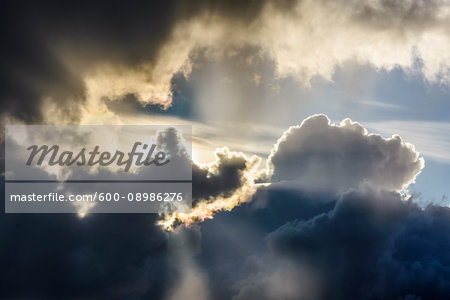 Sun breaking through the dramatic clouds at Loch Scavaig on the Isle of Skye in Scotland, United Kingdom