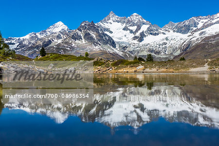 The Swiss Alps reflected in the small mountain lake of Grunsee at Zermatt, Switzerland