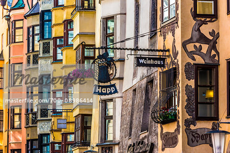 Detail of a row of colorful buildings with signs in the resort town of Innsbruck, Austria