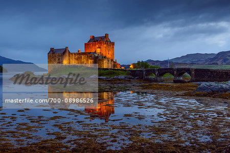 Eilean Donan Castle illuminated at dusk near Kyle of Lochalsh in Scotland, United Kingdom