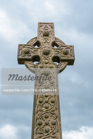 Celtic cross against cloudy sky at the Old Town Cemetery in Stirling, Scotland, United Kingdom