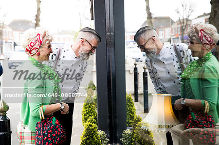 Quirky vintage couple window shopping at vintage shop