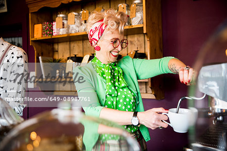 Quirky vintage mature woman working behind tea room counter