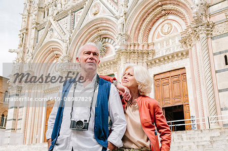 Tourist couple in front of Siena cathedral, Tuscany, Italy