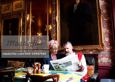 Quirky couple relaxing in bar and restaurant, Bournemouth, England