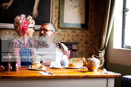 Quirky couple relaxing in bar and restaurant, Bournemouth, England