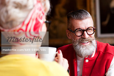 Quirky couple relaxing in bar and restaurant, Bournemouth, England