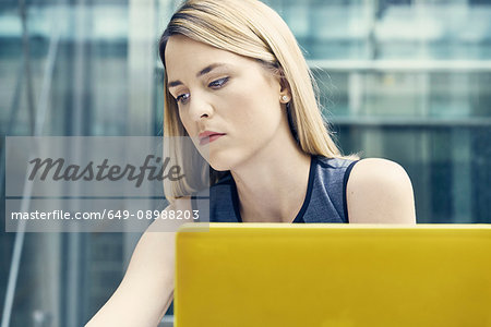 Young businesswoman looking down at office desk