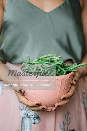 Woman with bowl of beans