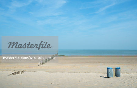 Waste bins and breakwater on beach, Cadzand, Zeeland, Netherlands, Europe