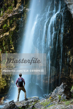 Hiker looking at waterfall, Accursed mountains, Theth, Shkoder, Albania, Europe