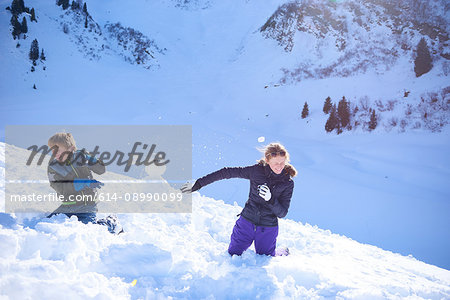 Siblings having snow ball fight, Hintertux, Tirol, Austria