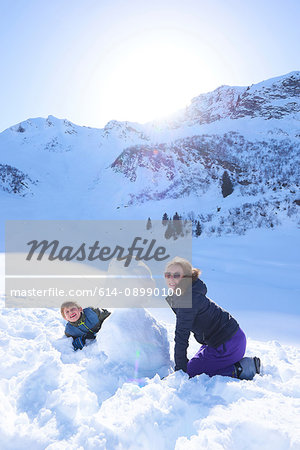 Siblings and snowman, Hintertux, Tirol, Austria