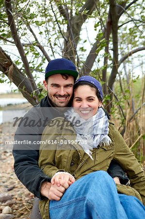 Portrait of happy young couple at beach