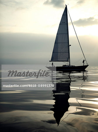 View of sailing boat on the ocean, calm sea.
