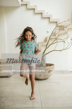 A girl running in a house.