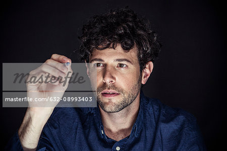 Man using stylus to write on transparent screen