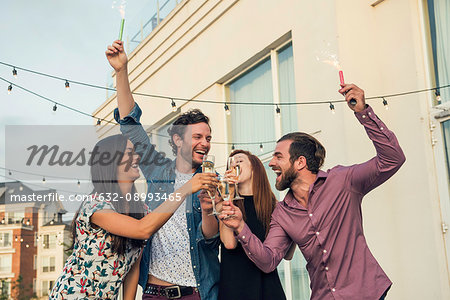 Friends celebrating with champagne outdoors