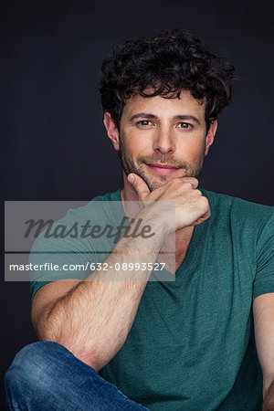 Man with hand under chin, smiling, portrait