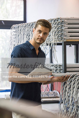 Man inspecting light bulbs in factory