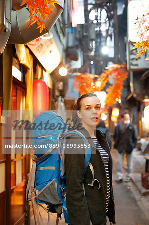 Caucasian backpacker downtown Tokyo at night, Tokyo, Japan Caucasian backpacker downtown Tokyo at night, Tokyo, Japan
