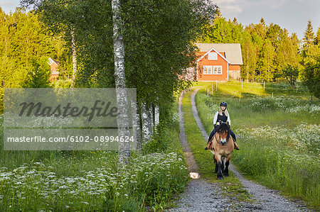 Young woman horseback riding