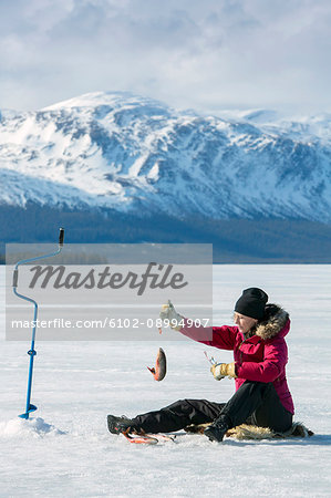 Woman ice fishing