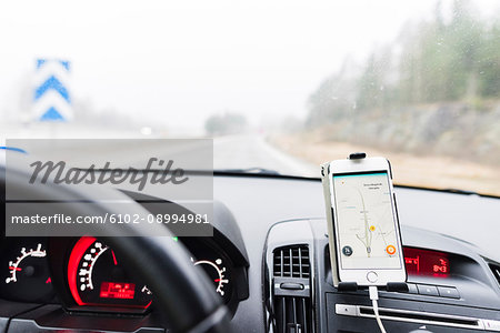 Cell phone showing map on dashboard