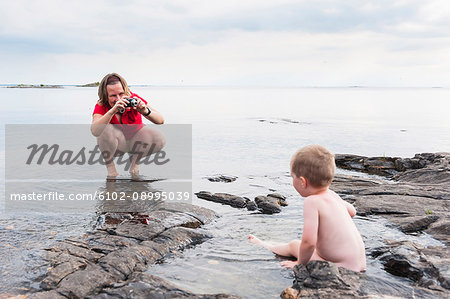 Mother taking picture of son
