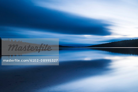 Stormy clouds reflecting in water