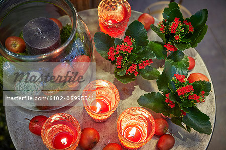 Red candles and flowers on table