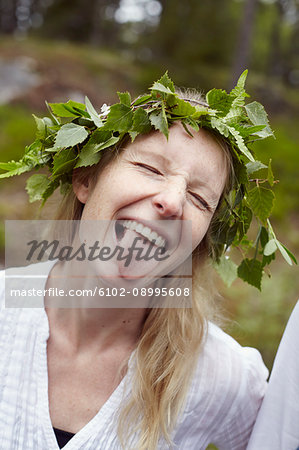 Happy woman wearing leaf wreath