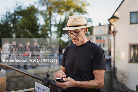 Mature man checking cell phone