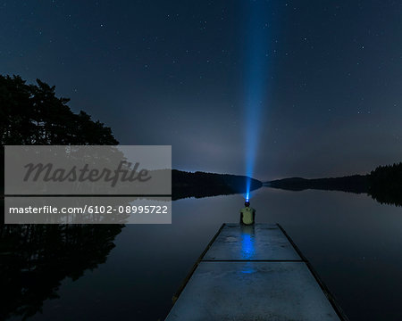 Person with headlight on jetty